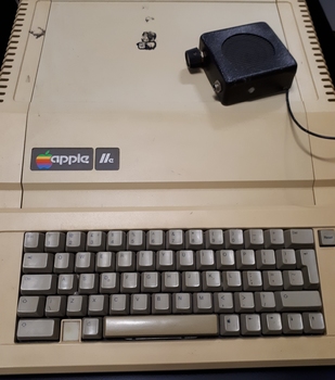 Beige case with dark brown keyboard and colourful Apple logo