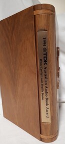 Wooden cassette box with title of award and name of book on spine