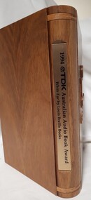Wooden cassette box with title of award and name of book on spine