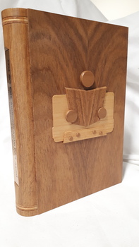 Wooden cassette box with title of award and name of book on spine and wooden picture of person reading a book