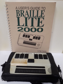 Booklet with Braille Lite machine and case