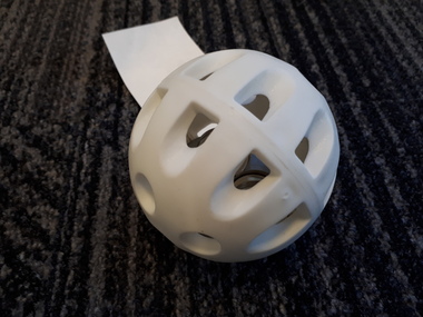 White plastic ball with gaps and metal ball inside