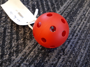 Red plastic ball with metal bell inside