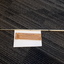 White metal cane and brown paper packet with labelling