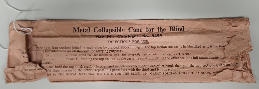 Damaged paper wrapper for white cane