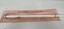 Close up view of handle and top of cane on paper envelope
