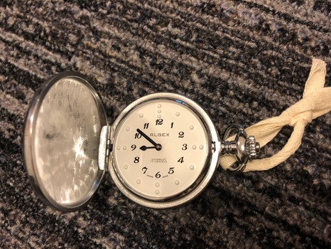 Silver pocket watch with Braille numbers