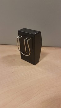 Black rectangular box with wire clip and prong on one side
