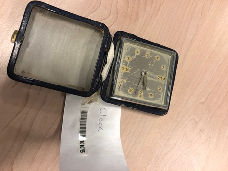 Clock inside dark blue travel case