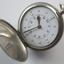 Open silver fob watch with Braille and print number display