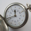 Open silver fob watch with Braille and print number display