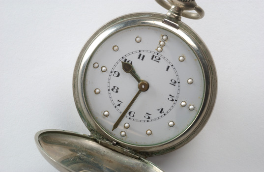 Open silver fob watch with Braille and print number display