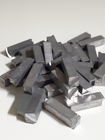 Pile of silver metal rods with square edges