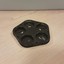 Black pentagon with five round holes in each corner