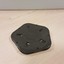 Black pentagon with five round holes in each corner