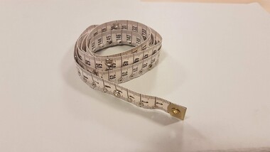 Tape measure with metal ends and metal eyelets punched in cm increments