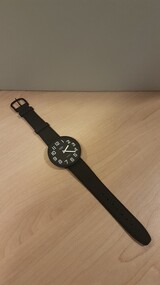 Large black watch with white writing