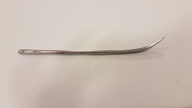 Steel needle with curved end and large hole for thread