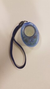 Metal circle set into see through plastic case with nylon carry handle