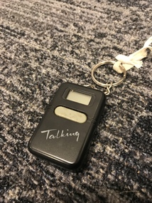 Black rectangle with light gray button and digital display