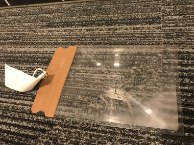 Magnifying sheet with vinyl handle