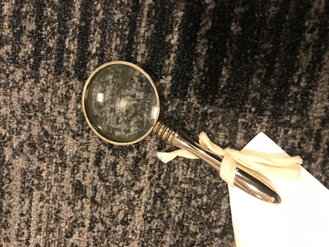 Silver metal handle and frame with round glass