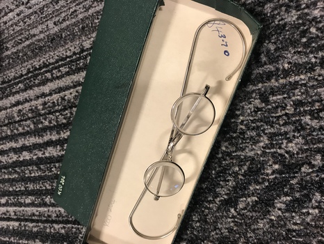 Silver frames with round lenses inside green box