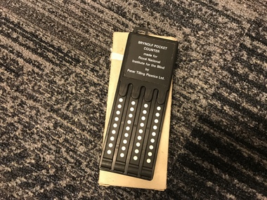 Black rectangle with four dials that can be moved along a series of white dots