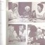 Three females playing cards.  Elderly resident is helped with needlework by a nurse.  A kitchen staffer gives a hug to an elderly resident.
