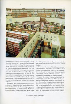 Overhead view of Braille and Talking Book library, with two men using the duplicators, one man shelving audio books and four female staff working at various tasks.