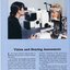 A woman peers into lens as she checks another woman's eyes at the Low Vision Clinic.