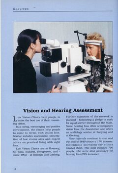 A woman peers into lens as she checks another woman's eyes at the Low Vision Clinic.