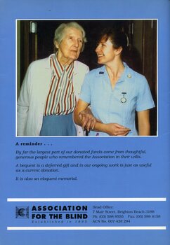 Elderly female being assisted by smiling nurse inside a nursing home.