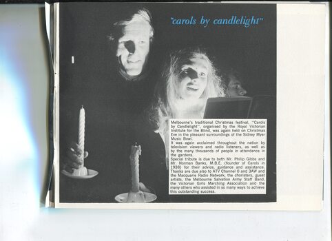 Update on Carols by Candlelight and picture of two adults holding candles and looking at a songbook