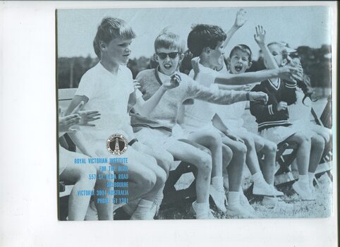 Group of children sitting on a bench, cheering at a sports event