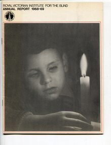 Young boy reaches reaches towards a candle set in front of him