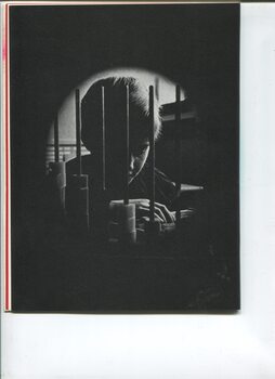 Pinhole view of child moving blocks on rods inside a classroom