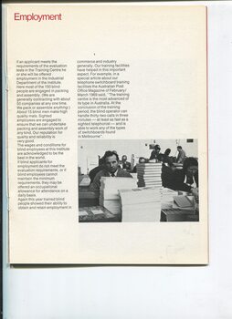 Packaging workshop with man seated behind a pile of boxes