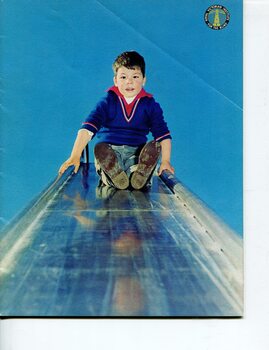 Boy about to slide down a metal slide