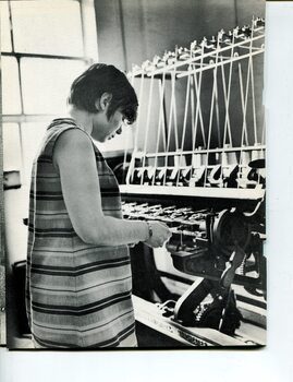 A young female operating a weaving machine in the RVIB Factory