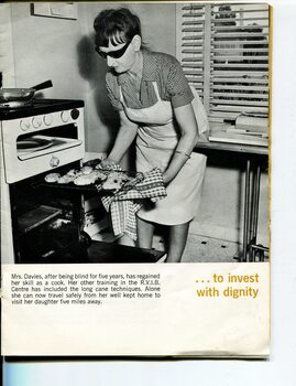Mrs Davies taking a tray of biscuits out of the oven