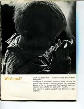 Young girl looks at her hands in semi-darkness
