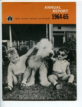 Two small boys pat a long haired dog