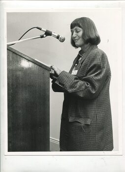 Fran Awcock speaks at the podium at the ceremony