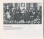 Photograph of Tilly Aston holding key to Commercial Road building, standing next to Senator G Fairbairn and surrounded by seated people on a stage