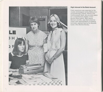 Janene Morrison uses a Perkins brailler, with Joan Harris and Mooma Queen Michele Worsley standing next to her