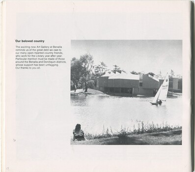 View of Benalla Art Gallery from across Lake Benalla with a small sail boat passing by