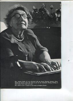 Photograph of Isadore Smith reading Braille in a lounge room
