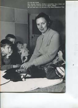 Dorothy Hamilton irons with four children around her