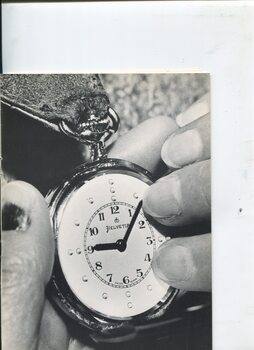 Hands feeling the time of a Braille fob watch